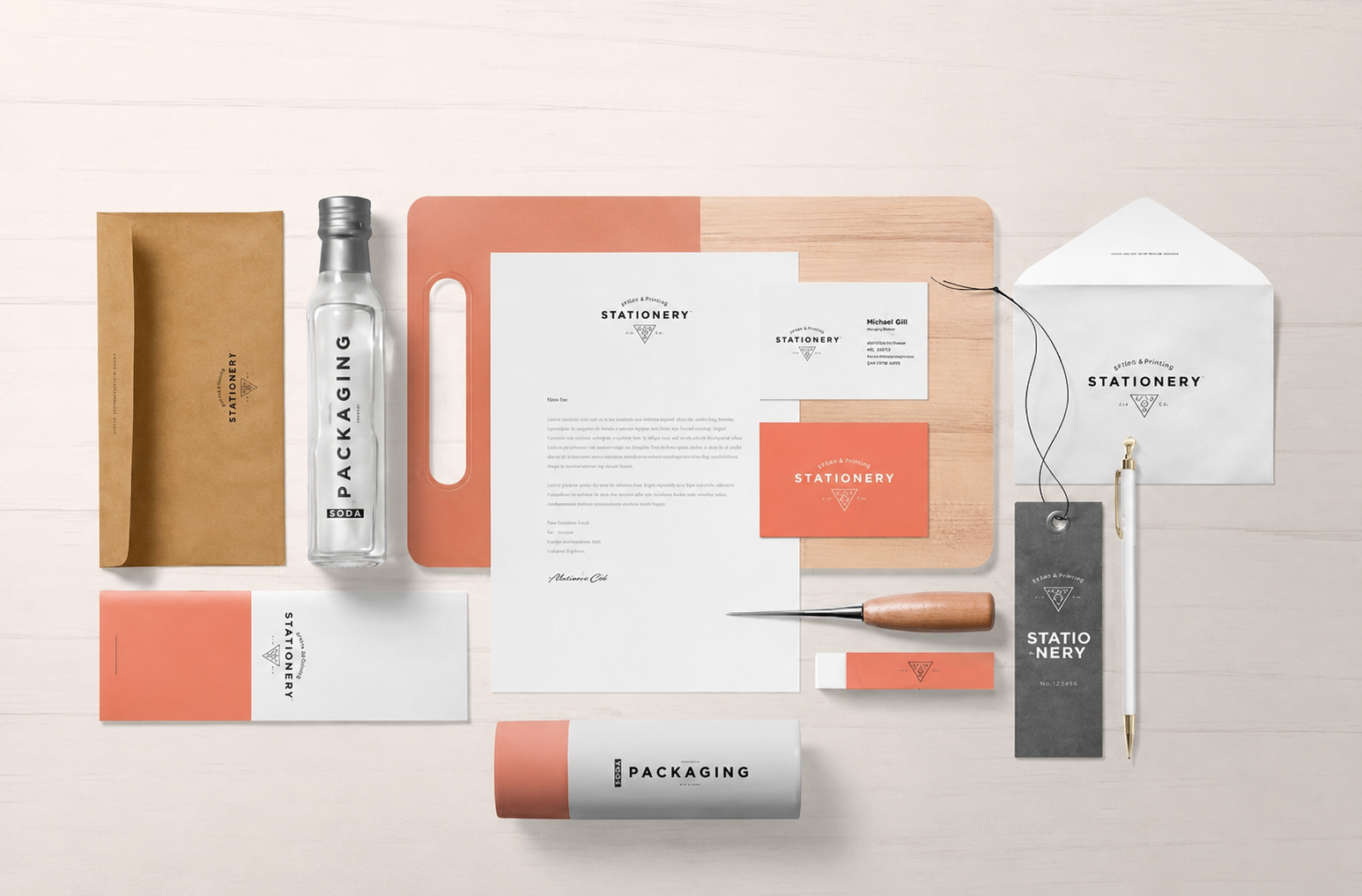 A minimalist brand identity: stationery, business cards, packaging and tags in coral red and white